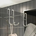Rust Resistant Multifunctional Shower Door Hook displayed on a sleek bathroom wall, ideal for towels and loofahs.