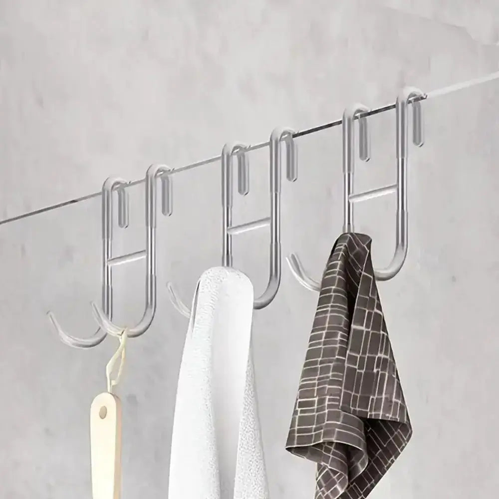 Rust Resistant Multifunctional Shower Door Hook displayed on a sleek bathroom wall, ideal for towels and loofahs.