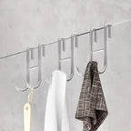 Rust Resistant Multifunctional Shower Door Hook displayed on a sleek bathroom wall, ideal for towels and loofahs.